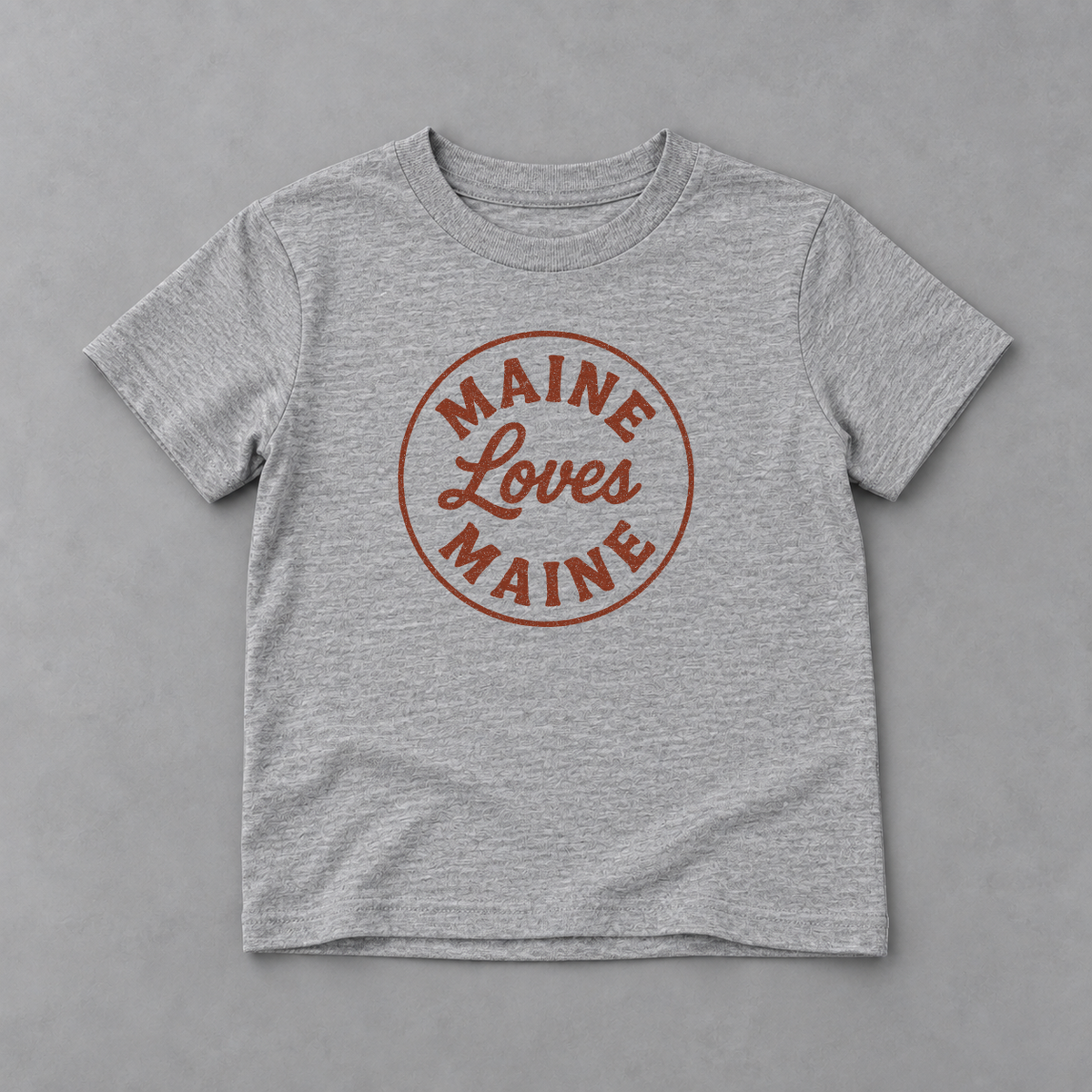 The Signal Tee kids athletic heather tee with red Maine Loves Maine logo, product flatlay