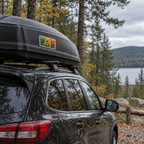 Windowpanes of Wildlife sticker on a rooftop cargo box in a wooded Maine setting