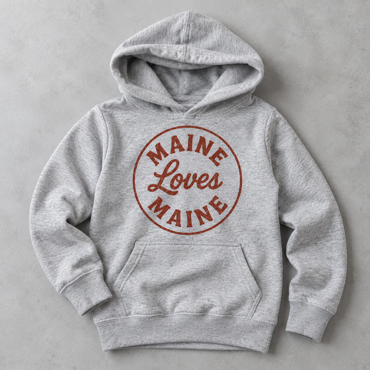 The Dockside Hoodie for kids in Heather Gray with red distressed Maine Loves Maine circle logo, approved flat lay