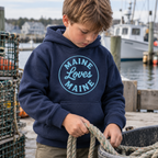 The Dockside Hoodie for kids in Navy with Ocean Spray distressed Maine Loves Maine circle logo, approved candid lifestyle image
