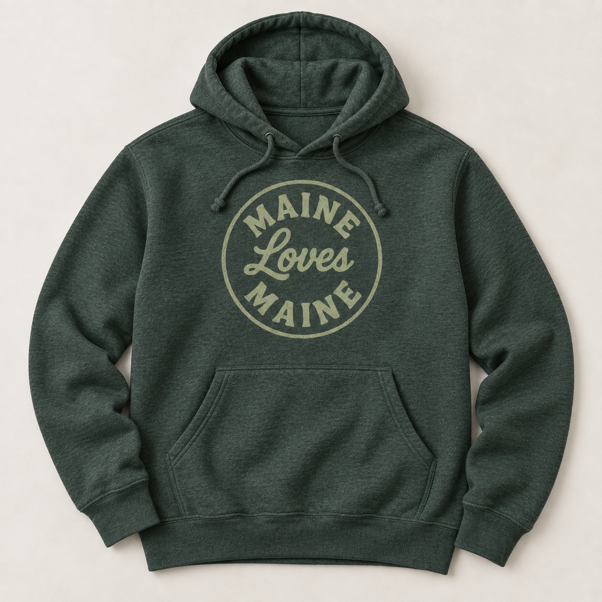 The Harbor Hoodie in Heather Forest with sage Maine Loves Maine circle logo, flat lay